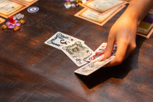 Close up photo of woman setting four fantasy playing cards on table