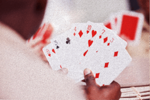 Close up photo of man holding playing cards