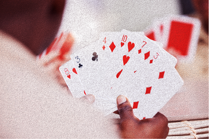 Close up photo of man holding playing cards
